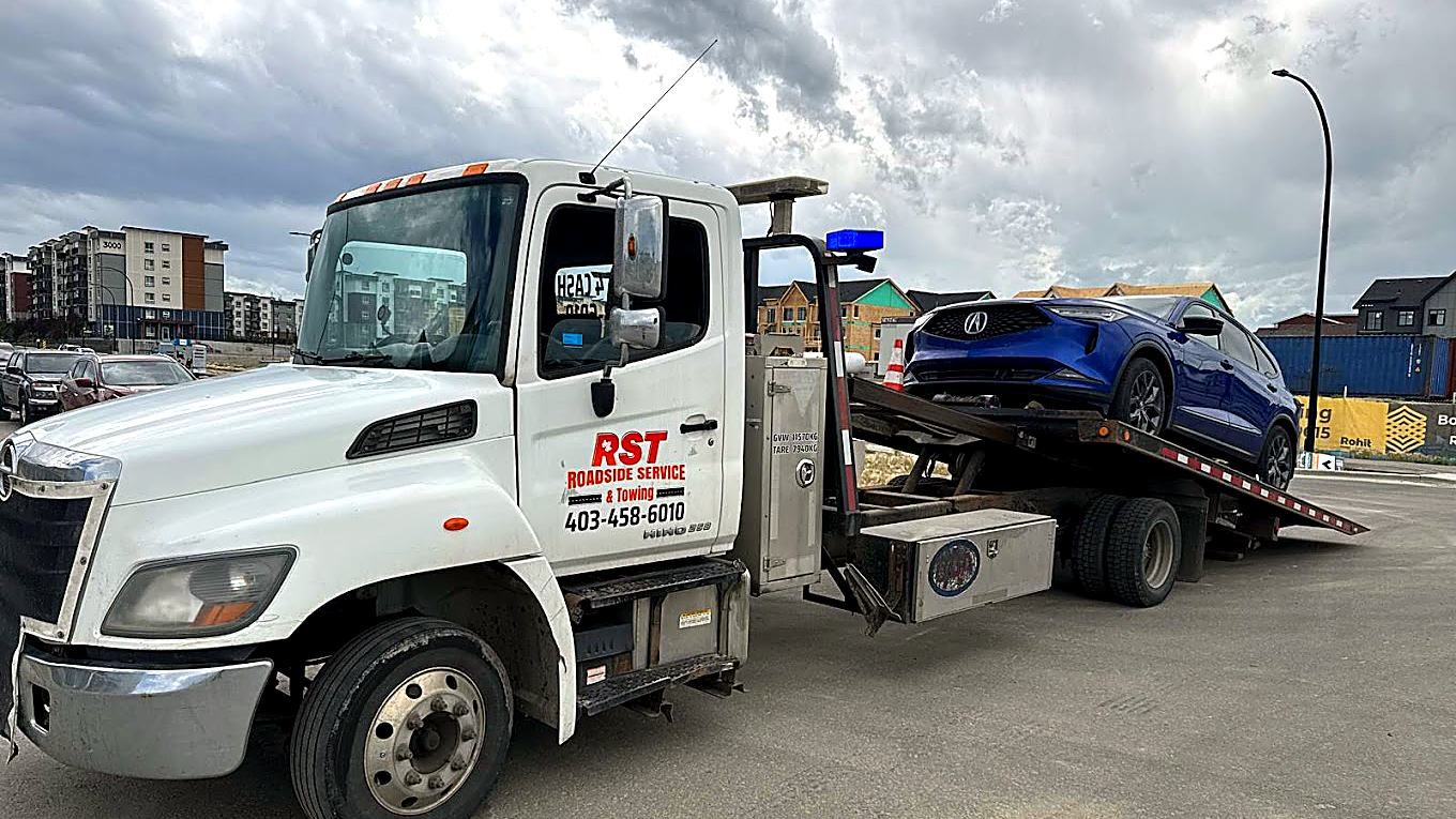 RST Roadside Service & Towing flatbed truck on location in Calgary