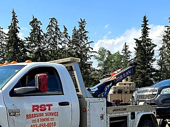 RST wrecker tow truck using wheel dollies to tow a vehicle in Calgary