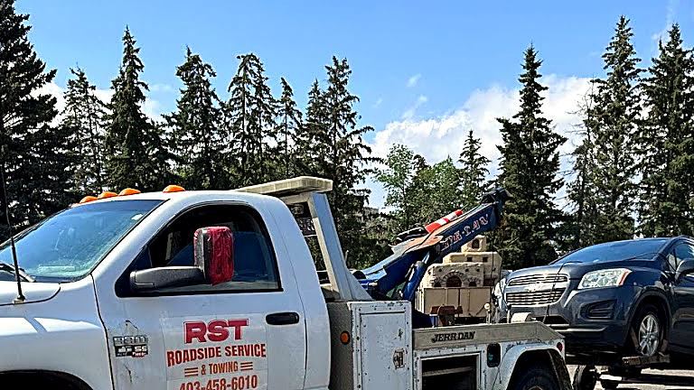 RST wrecker tow truck using wheel dollies on a vehicle in Calgary